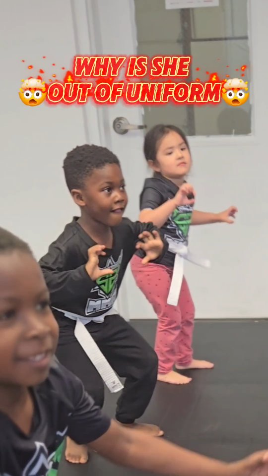 Young students in MMA stance during class