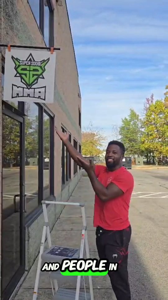 Sodiq Yusuff hanging the Super Sodiq MMA sign at the Waldorf academy