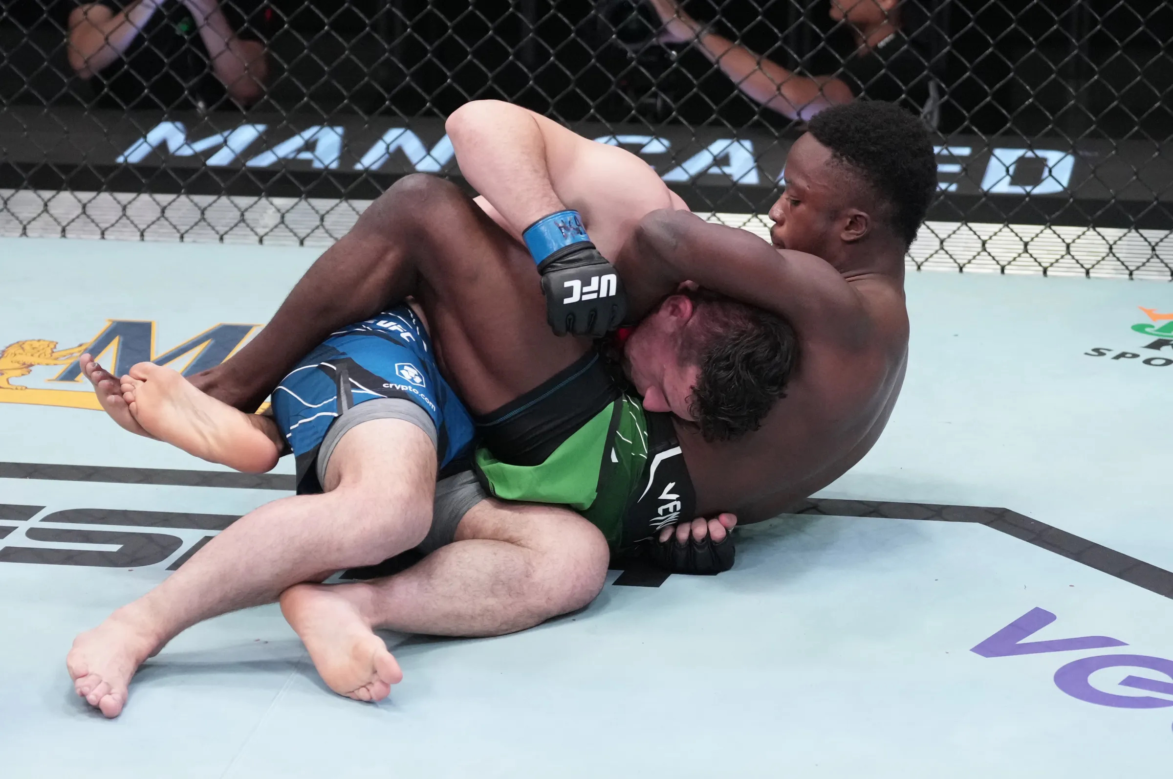 Sodiq Yusuff executing a submission in the UFC Octagon